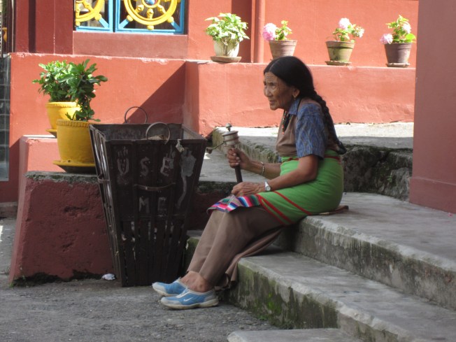 A Nepali woman sits outside the Jangchub Choeling Monastery in Pokhara.